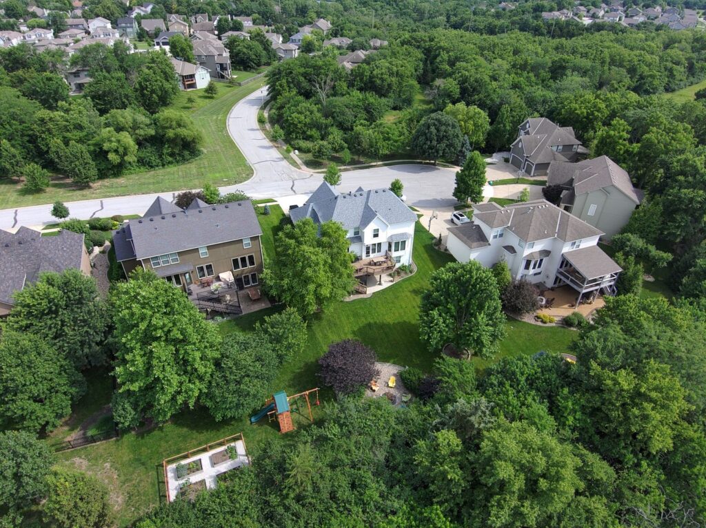 Houses and green yards of a suburban neighborhood seen from above